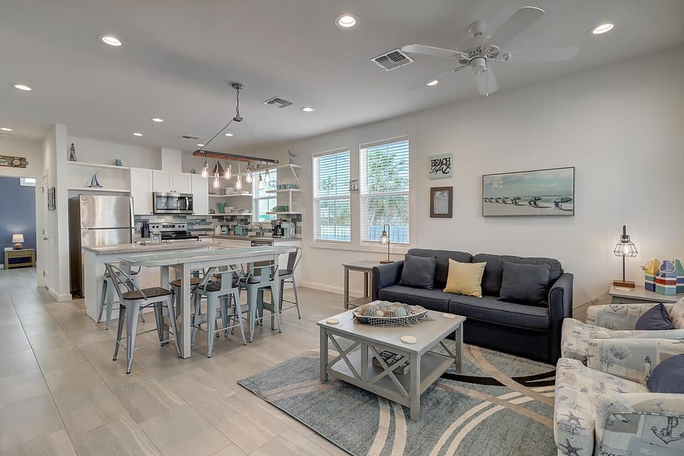 Unwind in your bright, open living space where modern coastal style meets comfort—complete with a fully equipped kitchen and cozy seating area.
