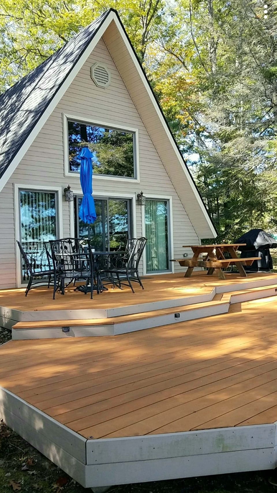 Large deck with beach chairs  and gas grill.