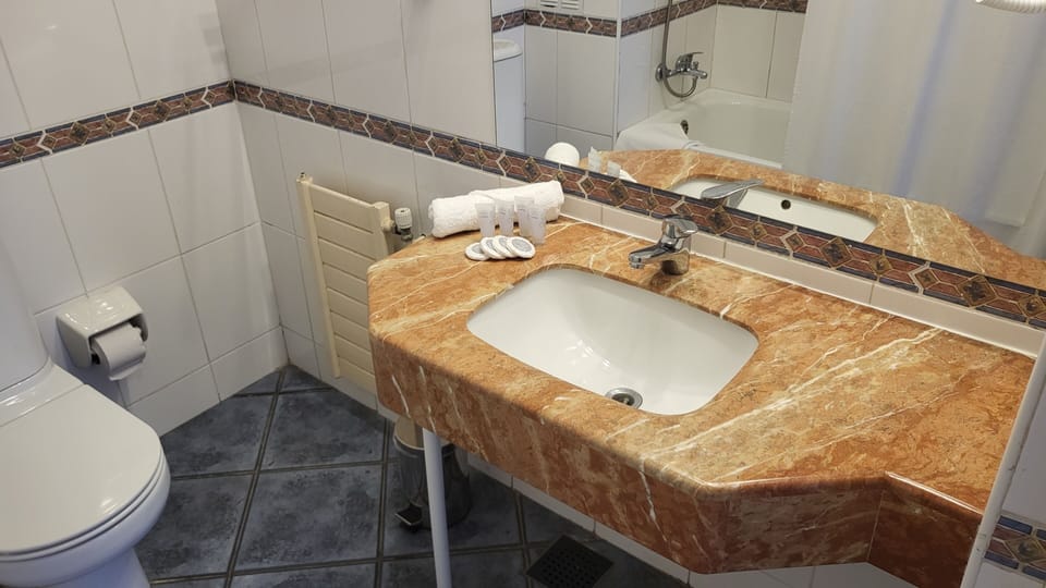 Standard Quadruple Room, Private Bathroom | Bathroom | Combined shower/tub, rainfall showerhead, designer toiletries
