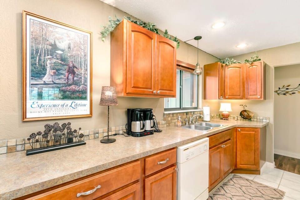 Kitchen with double coffee maker, dishwasher, and sink