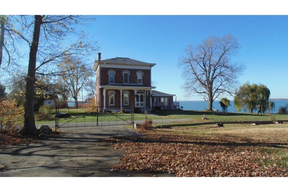 Front of house with view of Lake Erie behind. 