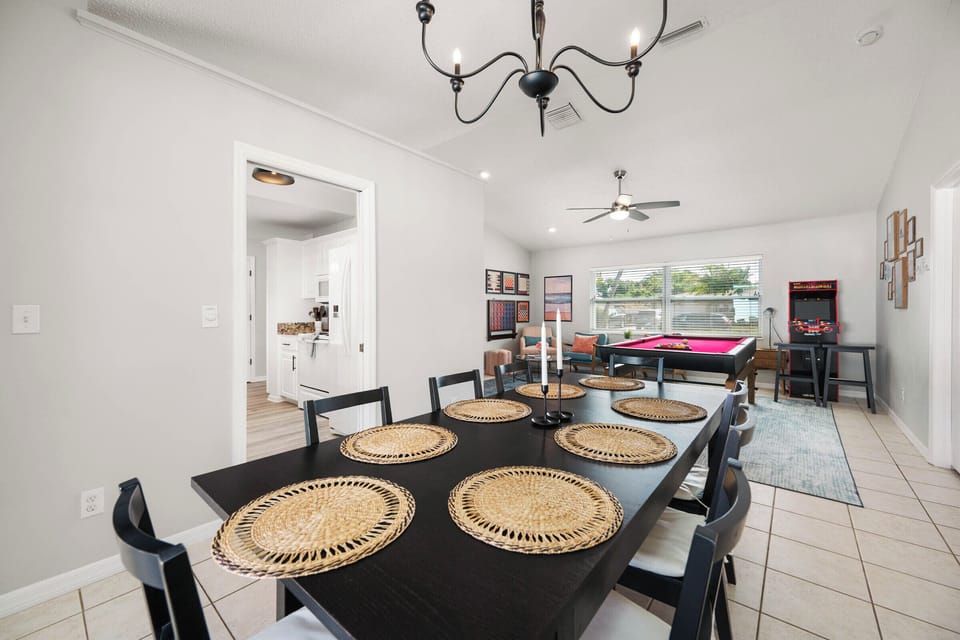A table for eight between the kitchen and game room keeping everyone connected