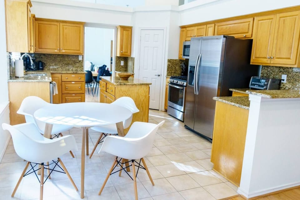 Brightly lit kitchen that comes with all of the essentials and more