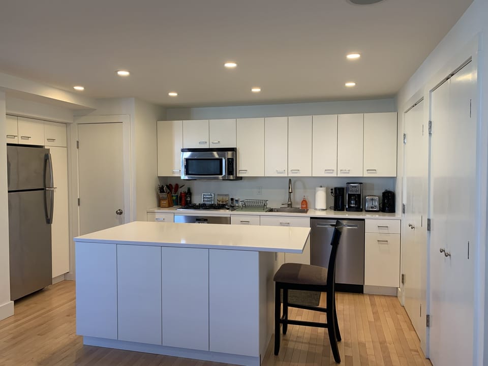 Full kitchen with stainless appliances, coffee maker, hot water kettle