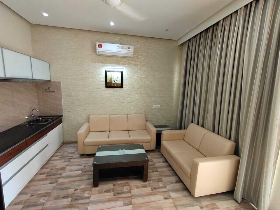 Family Quadruple Room | Living area | 42-inch LCD TV with satellite channels, TV