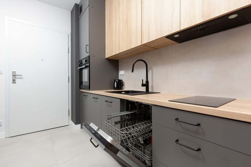 Kitchenette with plenty of kitchen utensils and dishes. 
