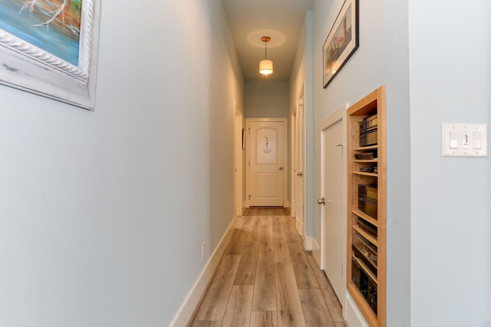 Hallway to garage, powder room, and laundry room
