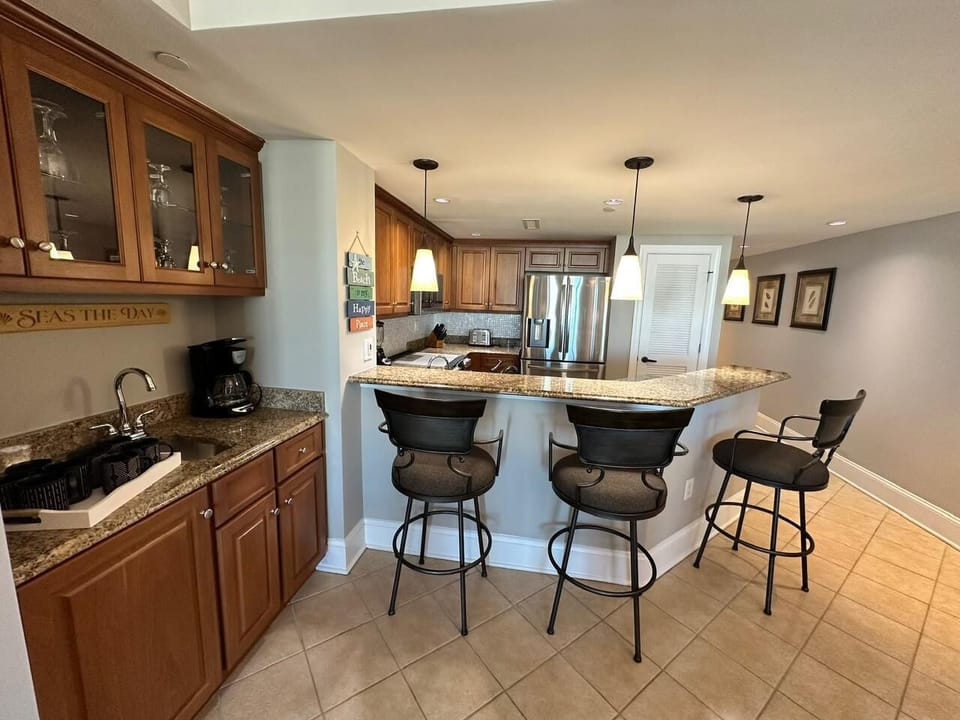 Cozy kitchen with breakfast bar and stainless steel appliances