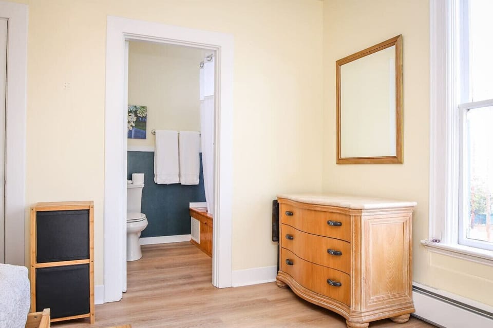 Dresser and walk in closet for ample clothing storage in the bedroom area.