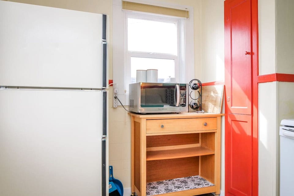 Full refrigerator/freezer, microwave, and closet ironing board.