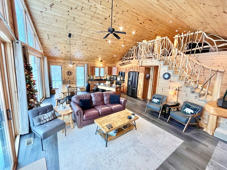 Relax in the Great room w/ plenty of comfy seating, fireplace, TV & river views!