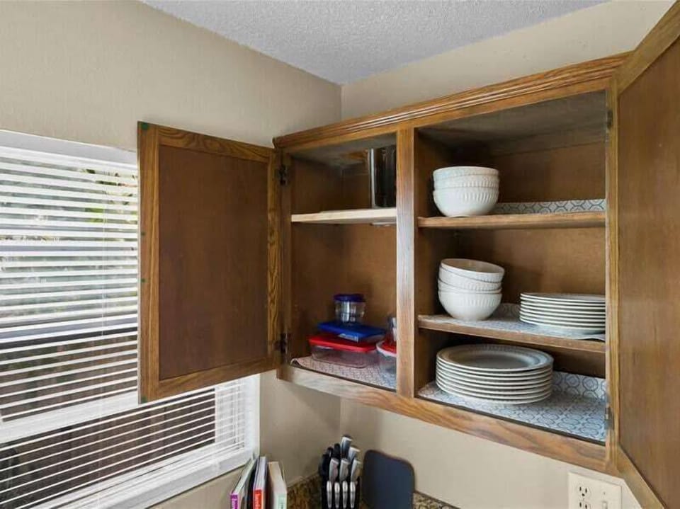 A file organizer can be used to store baking sheets and pans vertically, making them easy to find and pull out.