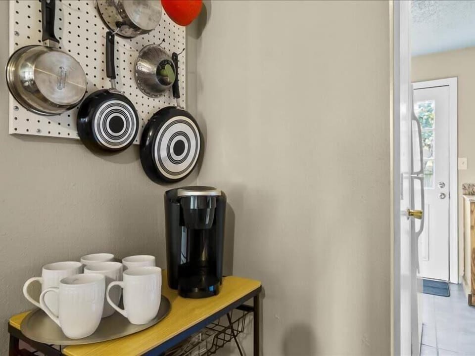 The beautiful cups, jug, and pans are some of the kitchenware items that can enhance the appearance and functionality of your cooking and dining space.