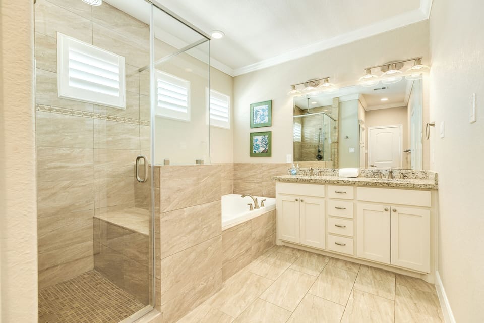 En suite primary bath with separate tub & shower
