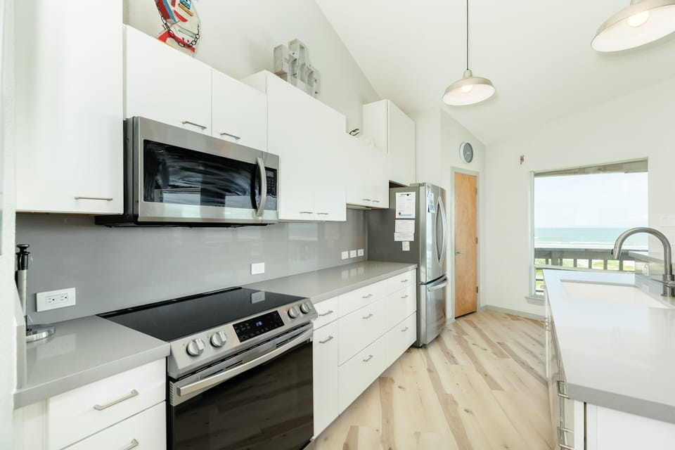 Fully equipped kitchen with abundant storage and stainless steel appliances