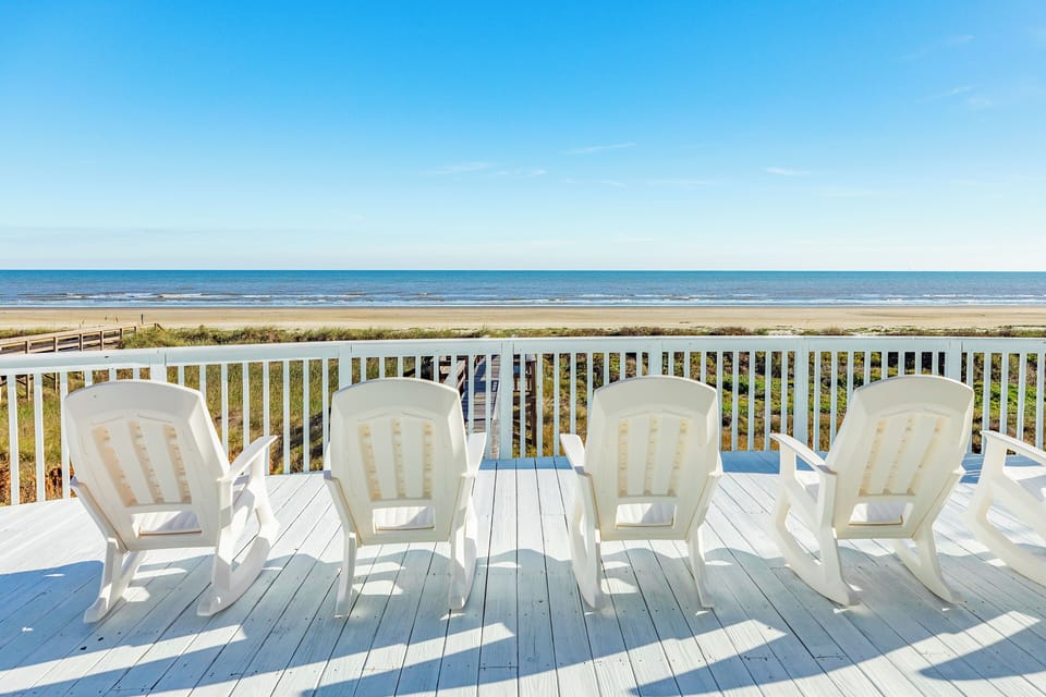 Watch the dolphins swim in the surf from the expansive deck