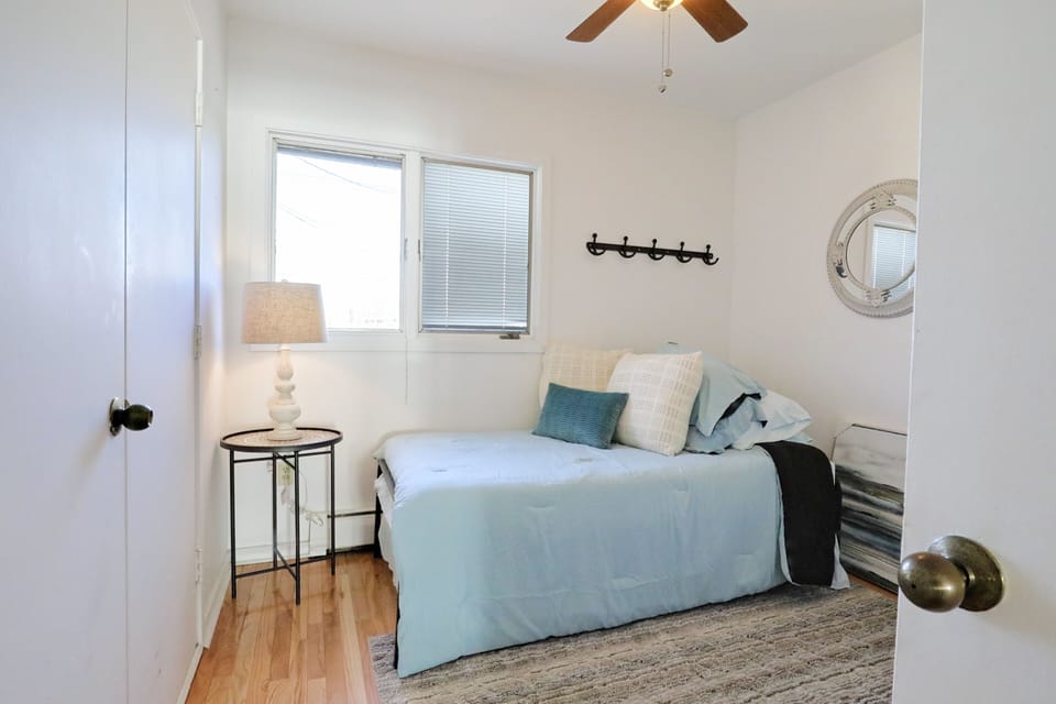 Back bedroom on the first floor with a twin bed and a trundle bed.  