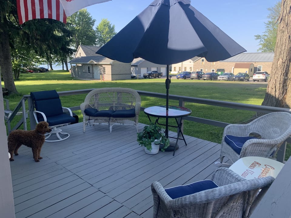 Large deck with bar with views of the River and the Village Green. Large yard.
