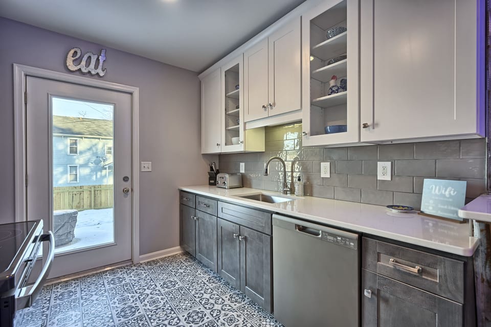 Designer kitchen with slate appliances, dishwasher, fridge and access to yard