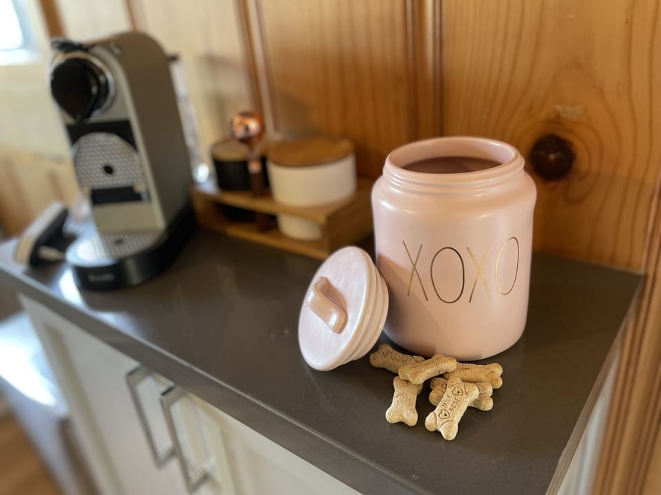 Fido is cared for, too. Bowls, cozy PAW blanket, and treats. Woof