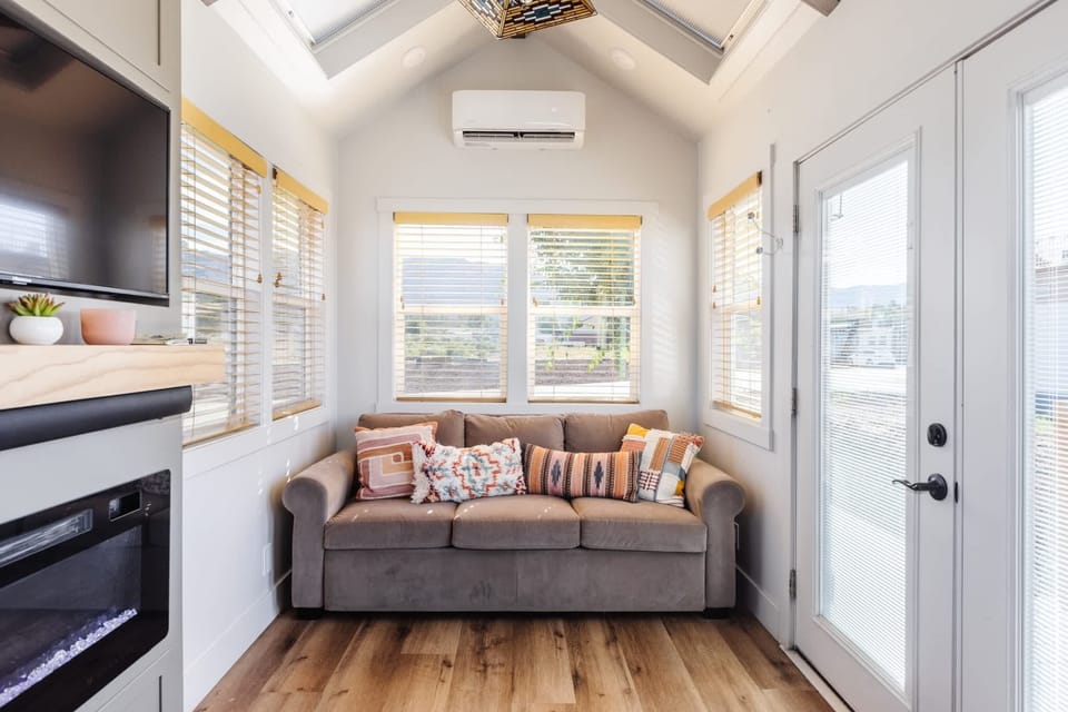 Inviting living area with comfortable sofa, large windows, and natural light for relaxing after hiking and exploring near Zion.