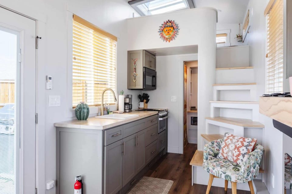 Open kitchen and loft stairway highlight the smart use of space inside Suncatcher near Zion National Park.