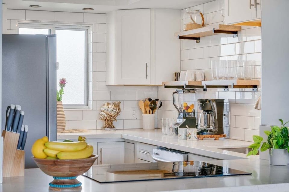 Fully equipped kitchen with stainless steel appliances, ample storage, and a clean, contemporary design.
