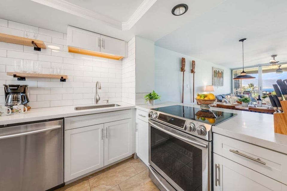 Modern kitchen featuring stainless steel appliances, granite countertops, and a spacious layout ideal for cooking island-inspired meals.
