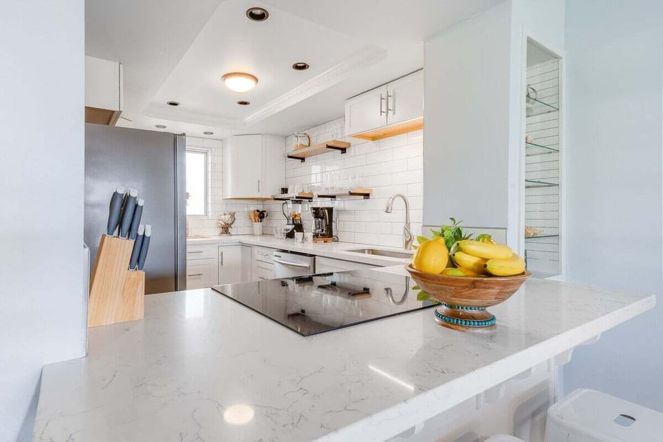 Sleek kitchen countertop with modern finishes and fresh fruit accents, ideal for preparing island-inspired dishes.