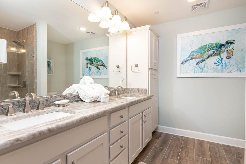 Experience relaxation with plush towels and a refreshing shower in the master bath, perfect for prepping for a beach day