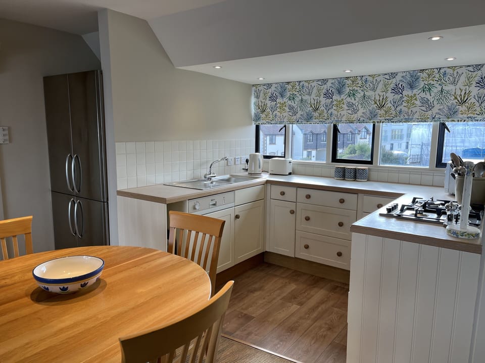 View of Kitchen area with large American size fridge in corner