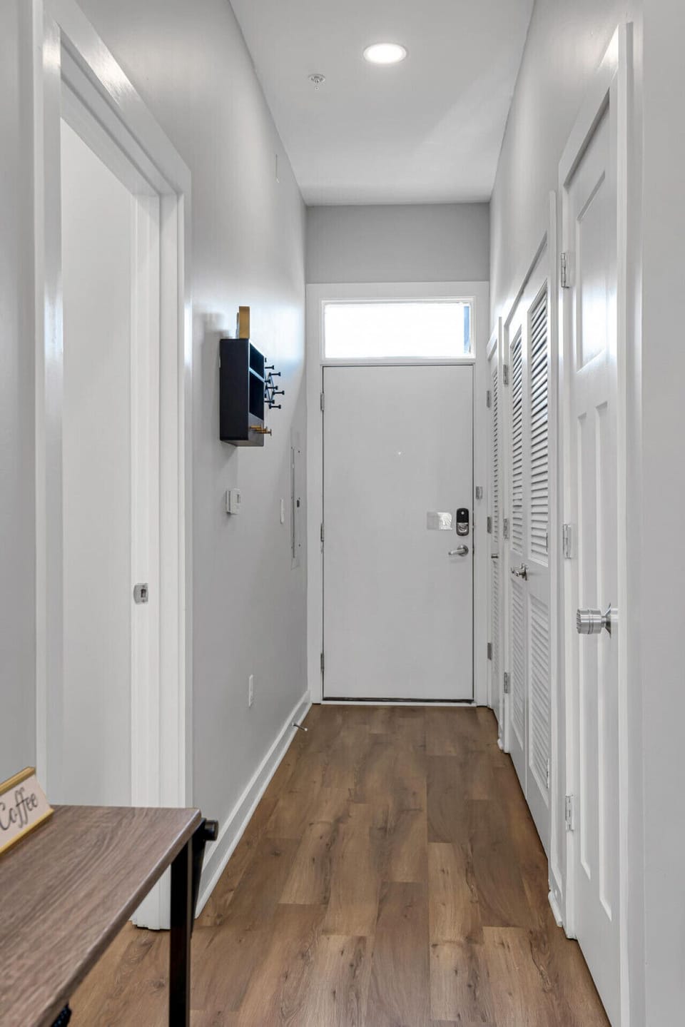 Spacious hallway leading to front door.