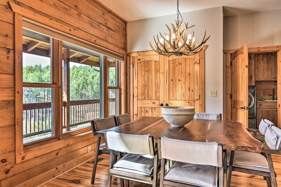 Set the dining table for a family-style meal beneath the antler chandelier.