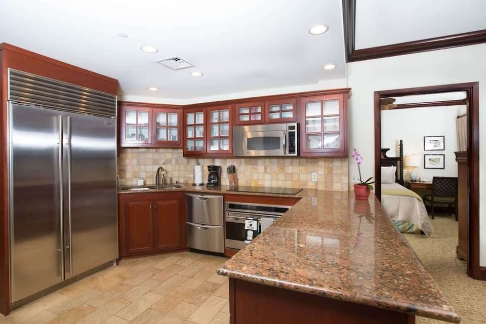 Gourmet chef's kitchen with granite, stainless steel & island views