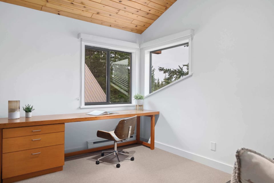 - Airy room with queen sofa bed and tall wood ceiling 
- Spacious desk area ideal for reading or remote work  
- Perfect blend of comfort and practicality for guests 