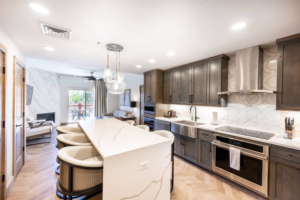 Indulge in culinary delights in our newly renovated kitchen, featuring a stunning waterfall granite countertop, and brand new appliances