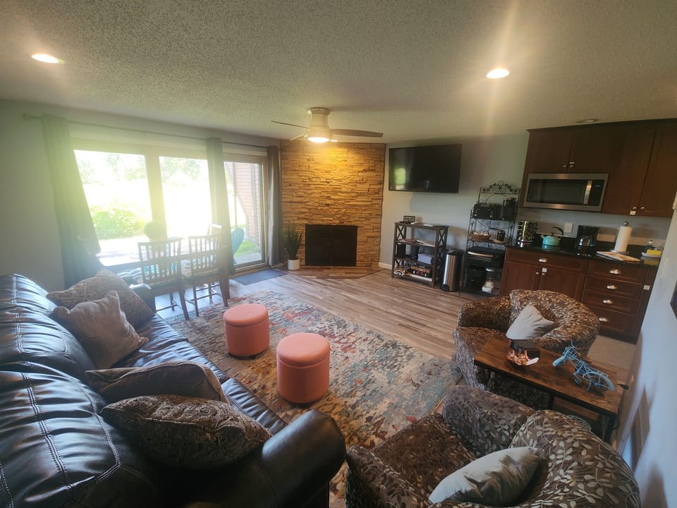 Open concept living room with views to patio