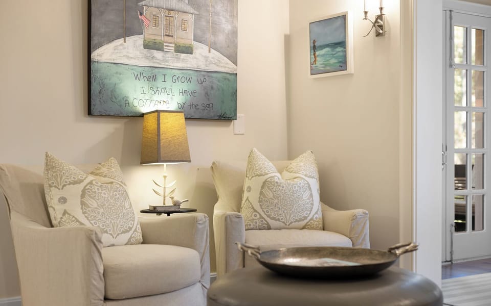 Sink into these plush armchairs and let the coastal artwork transport you to seaside serenity in your thoughtfully decorated retreat.