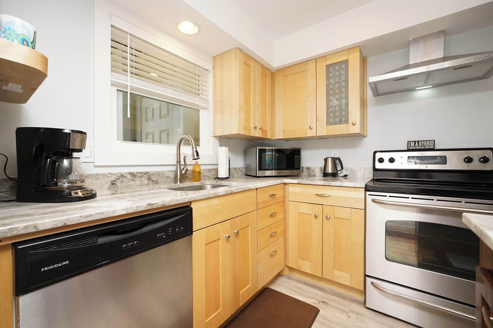 Your fully equipped kitchen features granite counters, stainless appliances, and warm wood cabinets—perfect for preparing memorable meals during your stay.