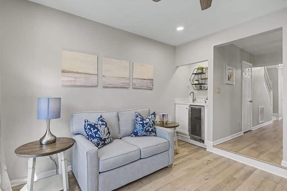 Sink into this cozy seating area where coastal charm meets modern comfort—your perfect spot to unwind after exploring.