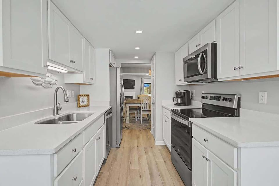 Your bright galley kitchen offers everything you need with modern appliances, ample counter space, and warm wood floors for culinary adventures.