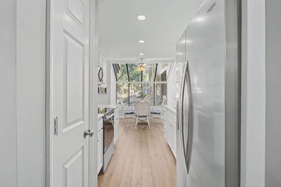 Your bright galley kitchen flows seamlessly to a cozy dining nook, where morning coffee tastes better with garden views.