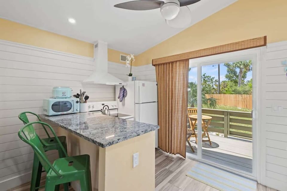 The bright kitchen and living area opens up to an outdoor patio perfect for soaking up the sun