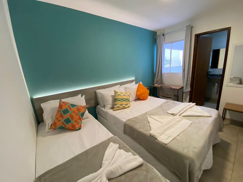 Triple Room, Side City View | Desk, laptop workspace, bed sheets
