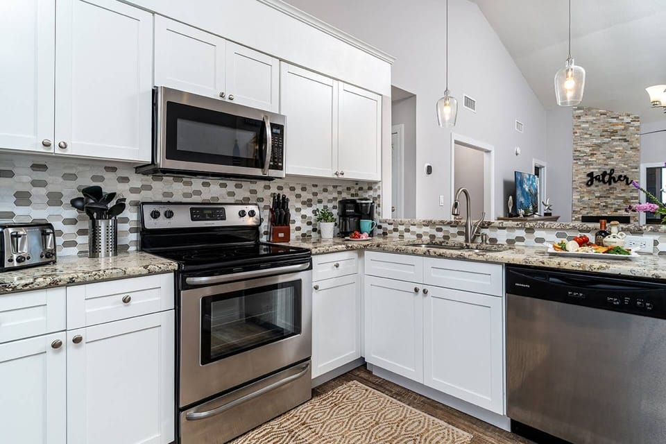 Spacious Kitchen with Stainless Steel Appliances & Granite Countertops