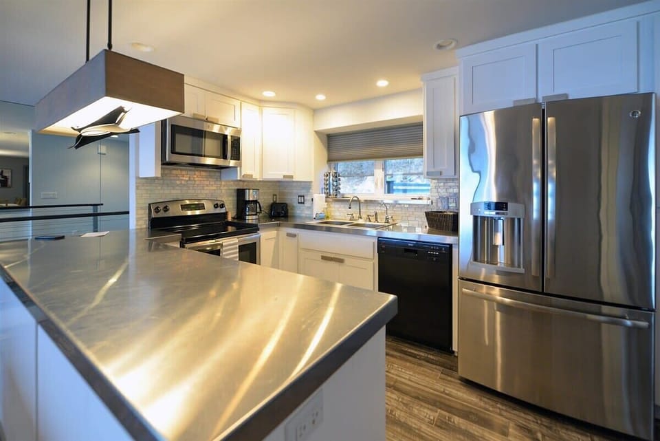 Your fully equipped modern kitchen features stainless steel appliances, granite countertops, and everything needed for memorable meals.