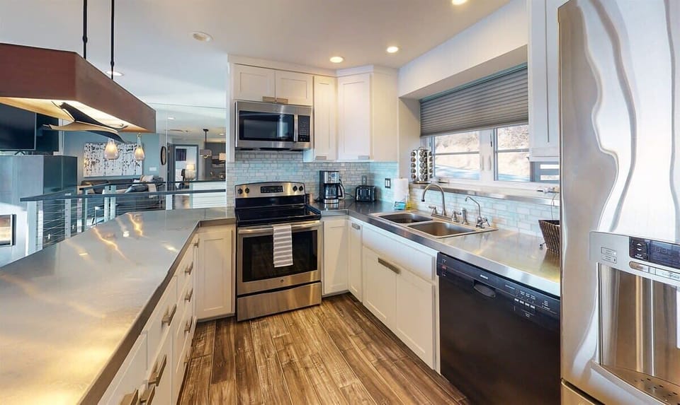 Your fully equipped kitchen awaits with sleek granite counters, stainless steel appliances, and bright windows for cooking memorable meals together.