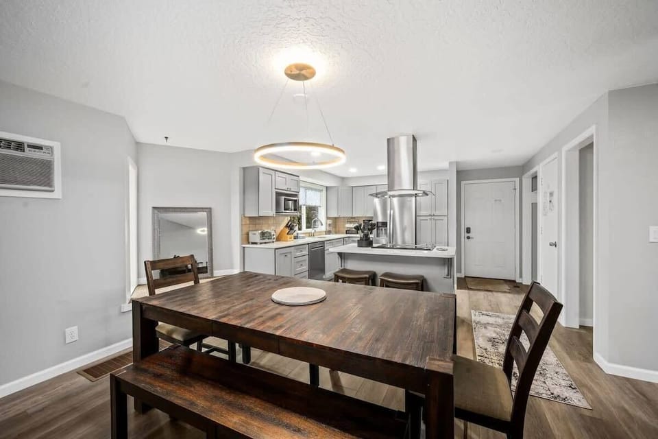 Your open-concept kitchen and dining area features modern appliances and warm wood finishes, perfect for preparing meals and gathering together.
