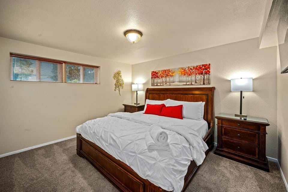 Sink into comfort with crisp linens and soft carpet beneath your feet in this inviting bedroom retreat.