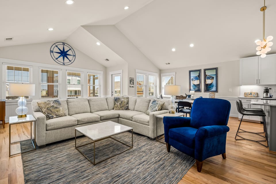 Open concept living room.  75" Samsung TV w/ Roku, soundbar, sofa, & recliner.